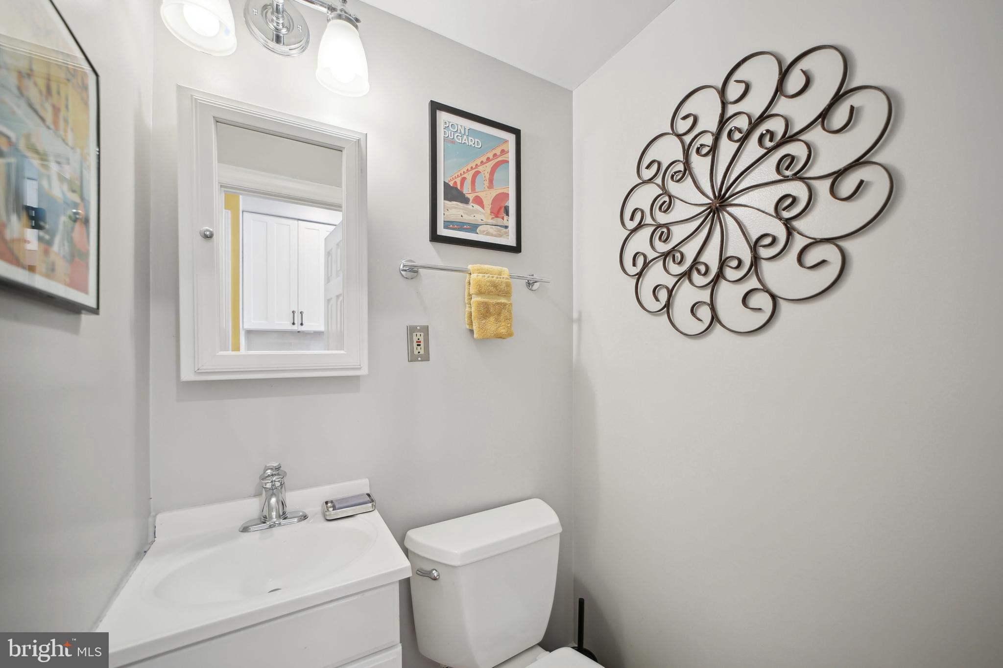 432 15th Street Southeast Washington, DC 20003 - Photo 12 of 26 a white toilet sitting next to a bathroom sink