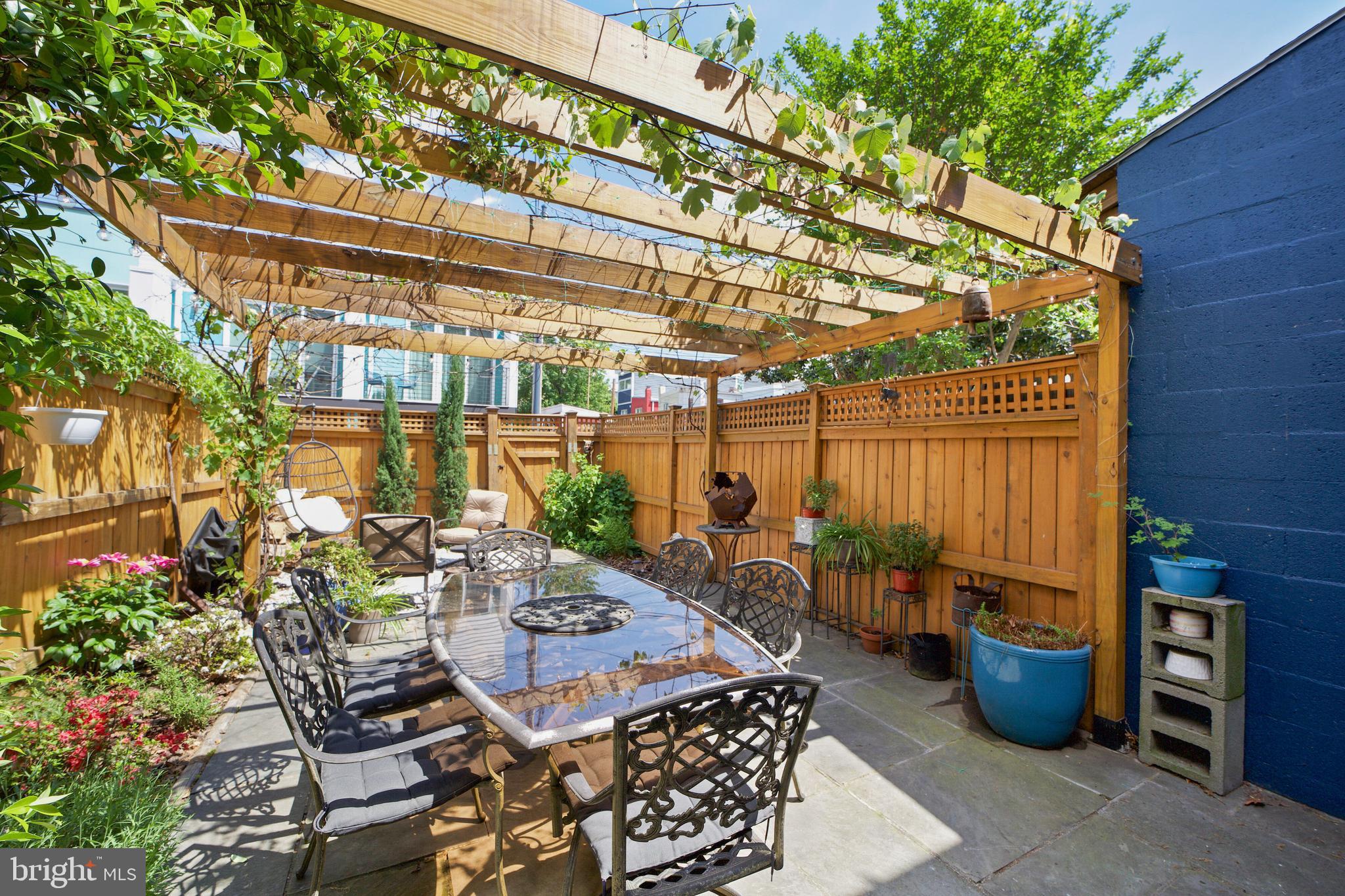 432 15th Street Southeast Washington, DC 20003 - Photo 22 of 26 a view of a patio with table and chairs potted plants
