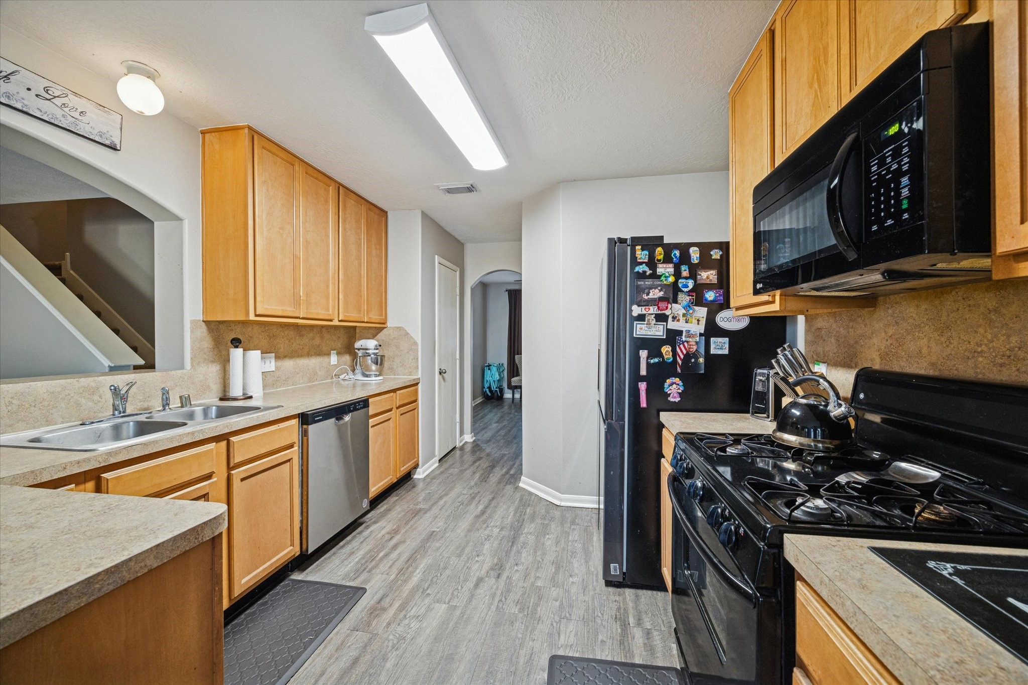 5243 El Tigre Lane Baytown, TX 77521 - Photo 12 of 29 a kitchen with stainless steel appliances granite countertop a stove a sink and a refrigerator