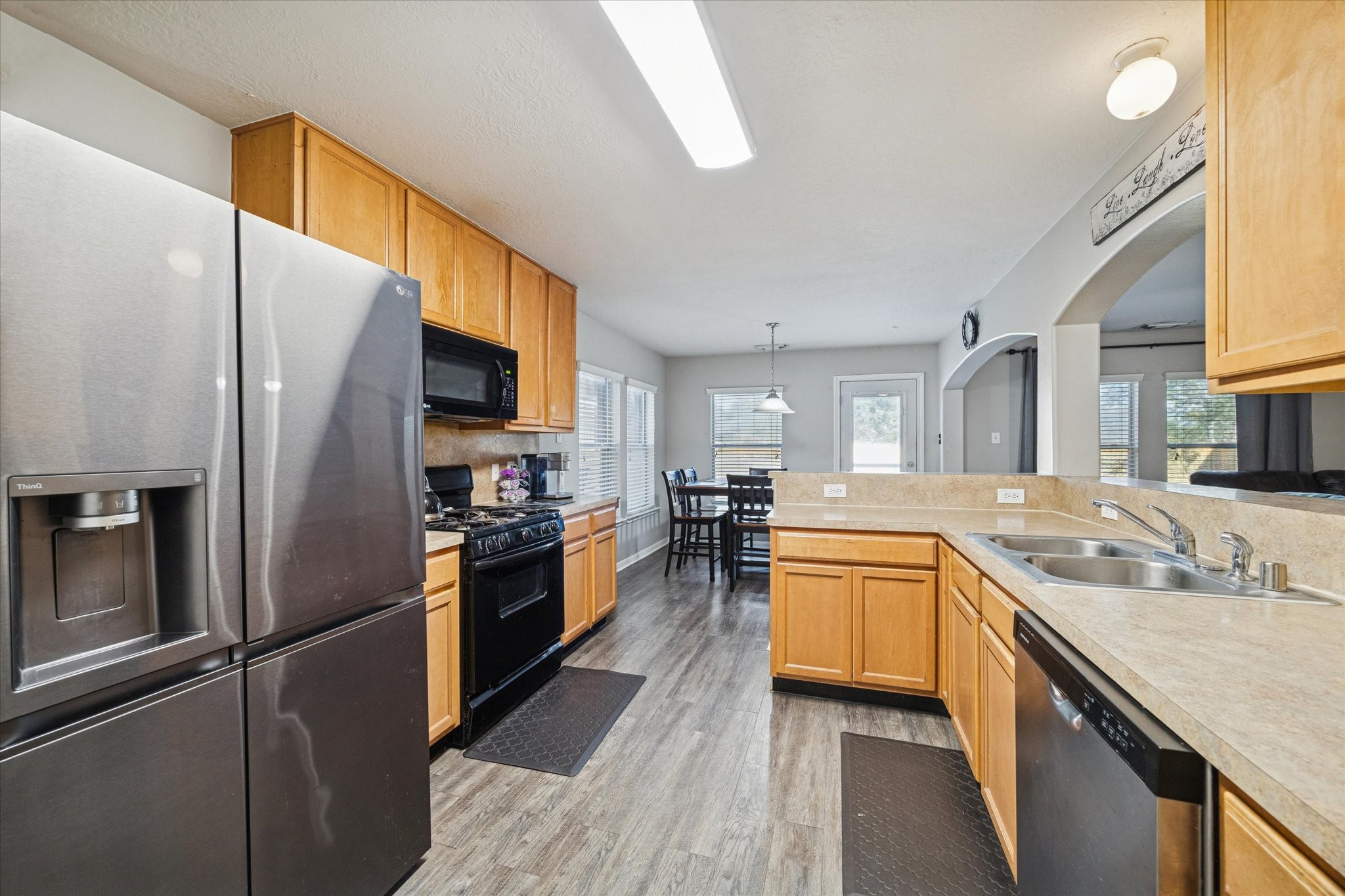 5243 El Tigre Lane Baytown, TX 77521 - Photo 13 of 29 a kitchen with a refrigerator sink and stove