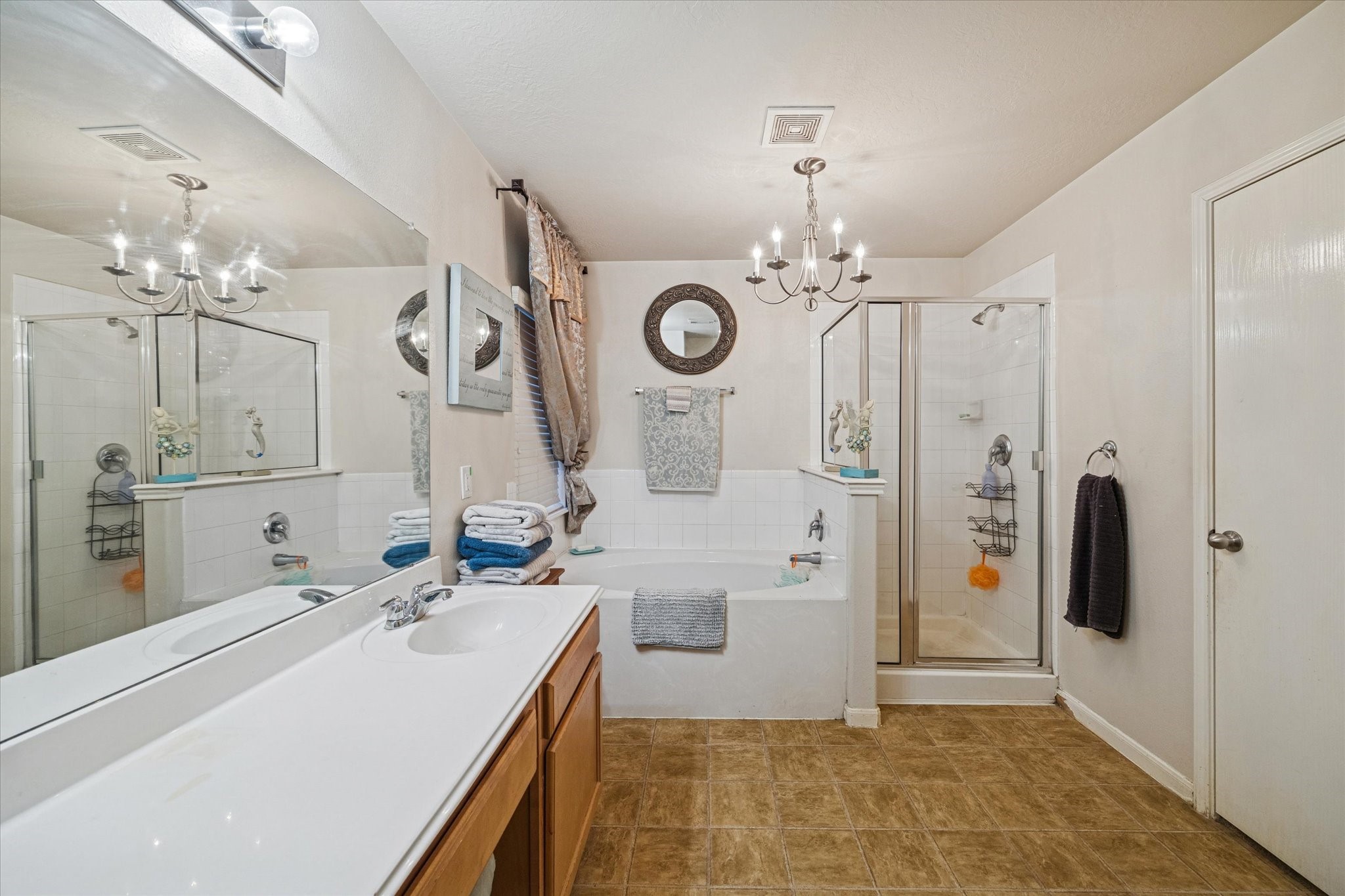 5243 El Tigre Lane Baytown, TX 77521 - Photo 16 of 29 a bathroom with a double vanity sink mirror and shower