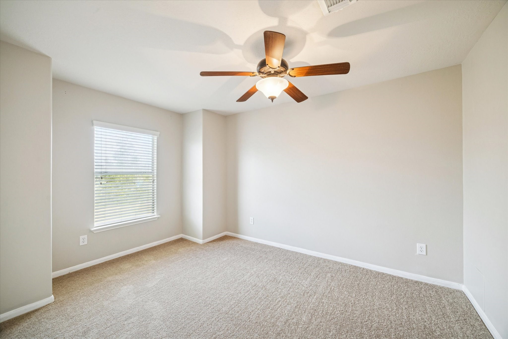 5243 El Tigre Lane Baytown, TX 77521 - Photo 22 of 29 an empty room with windows and fan