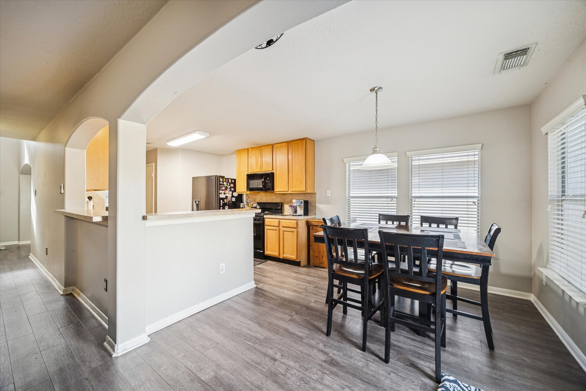 5243 El Tigre Lane Baytown, TX 77521 - Photo 7 of 29 a view of a dining room with furniture window and wooden floor