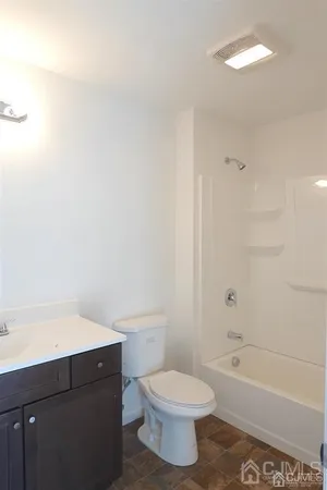 a bathroom with a toilet a sink and bathtub