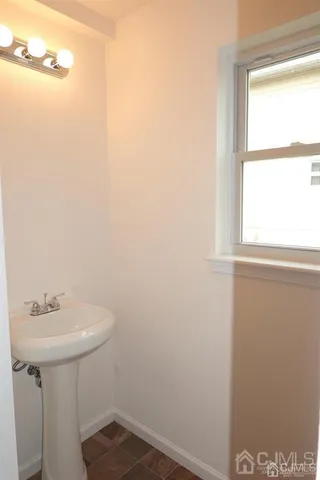 a bathroom with a sink and a window