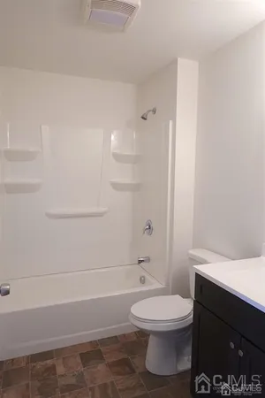 a bathroom with a toilet a sink and bathtub