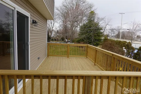 a balcony with wooden floor in front of house
