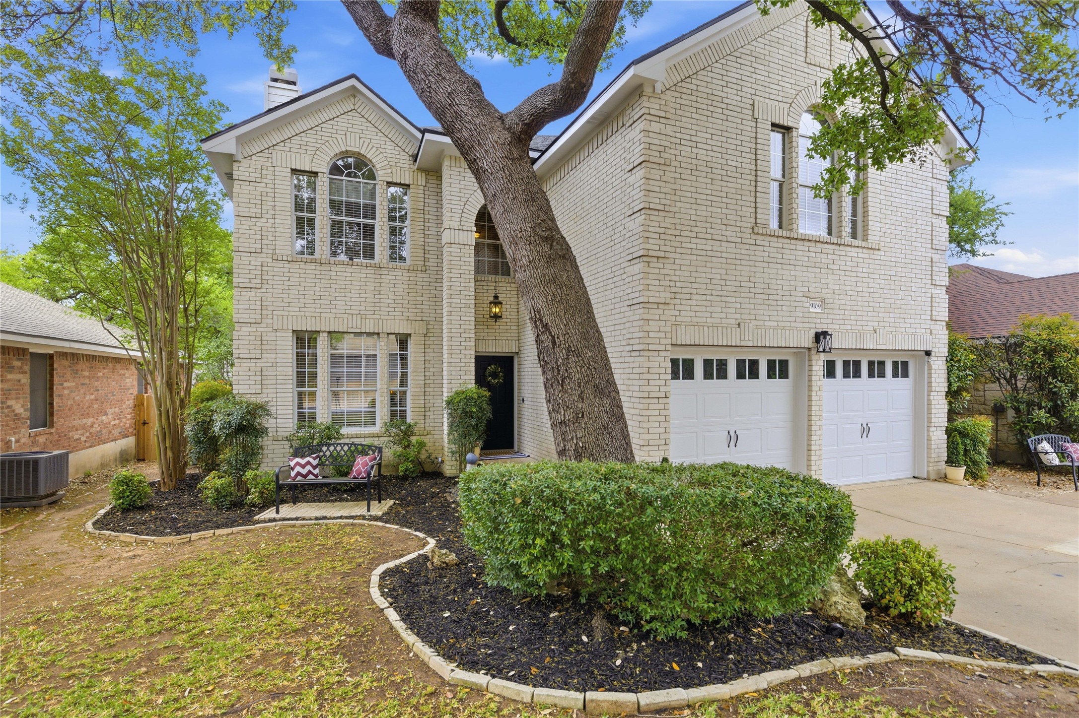 9109 Wampton Way Austin, TX 78749 - Photo 1 of 1 a view of a white house with large windows and a small yard