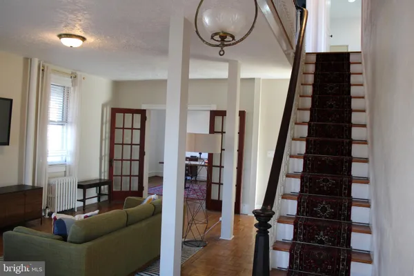 a living room with furniture and wooden floor
