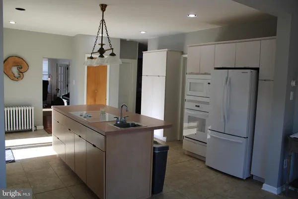 a kitchen with stainless steel appliances granite countertop a refrigerator and a stove
