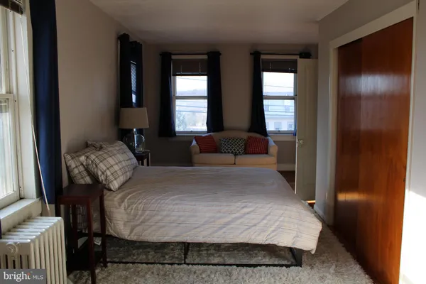a bed sitting in a bedroom next to a window