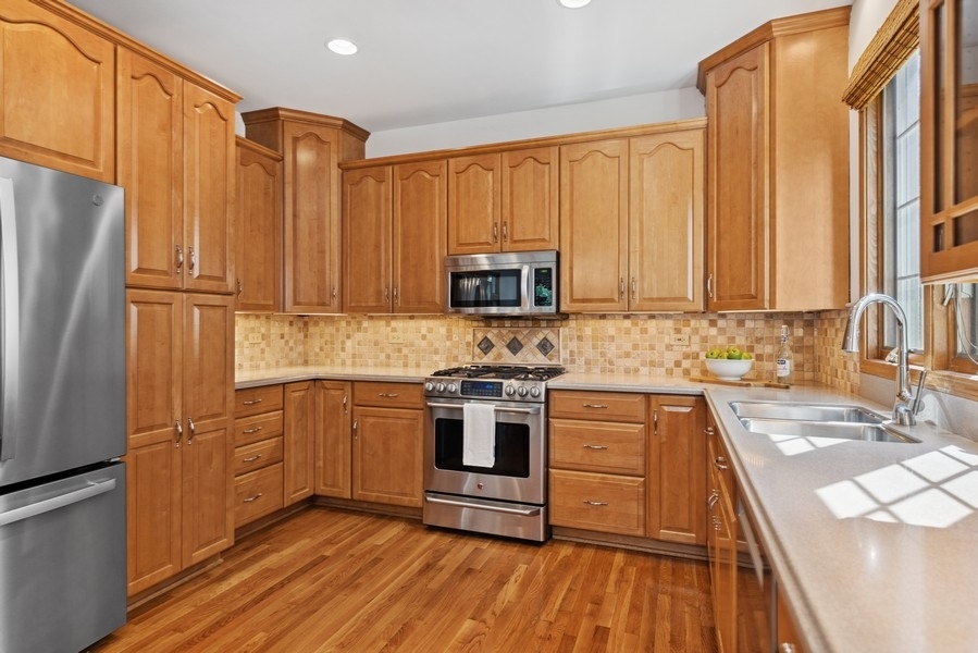 324 North County Line Road Hinsdale, IL 60521 - Photo 6 of 32 a kitchen with stainless steel appliances a refrigerator stove and sink