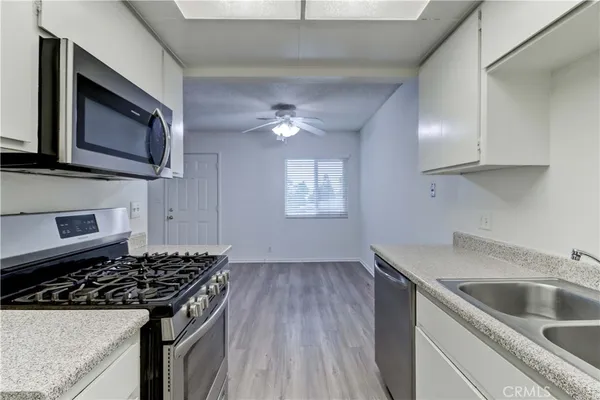 a kitchen with cabinets appliances and a sink