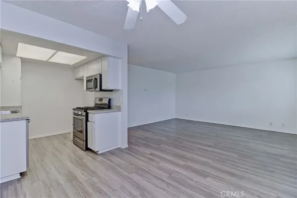 a kitchen with wooden floor and window