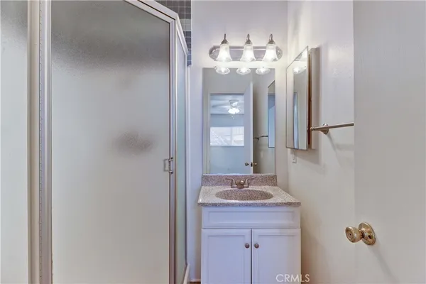 a bathroom with a sink vanity and mirror