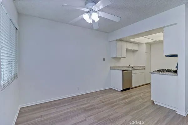 a kitchen with granite countertop a stove a refrigerator and a chandelier