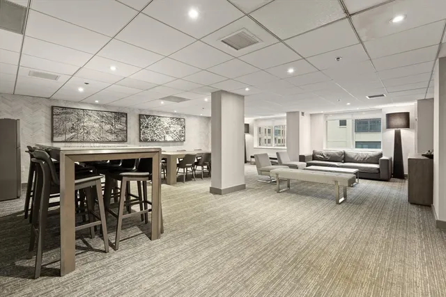 a living room with furniture a table and chairs