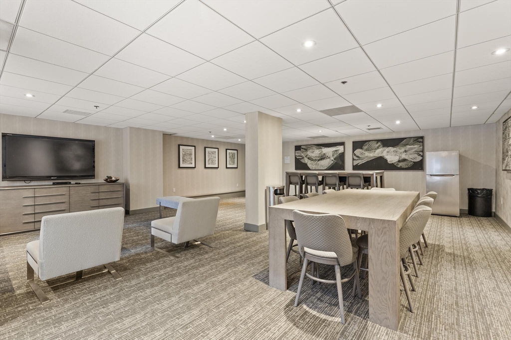 8 Museum Way, Unit 1103 Cambridge, MA 02141 - Photo 20 of 42 a living room with furniture and a flat screen tv