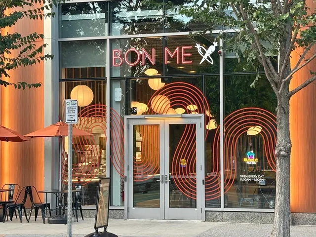 a view of a building with a tree in front of retail shop