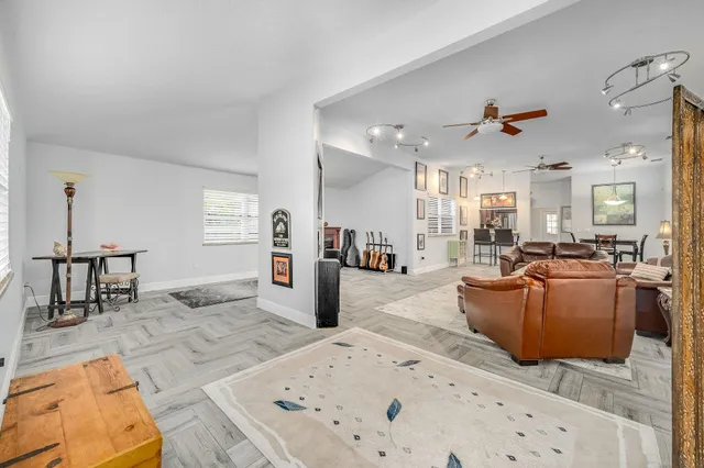 a living room with furniture and a dining table