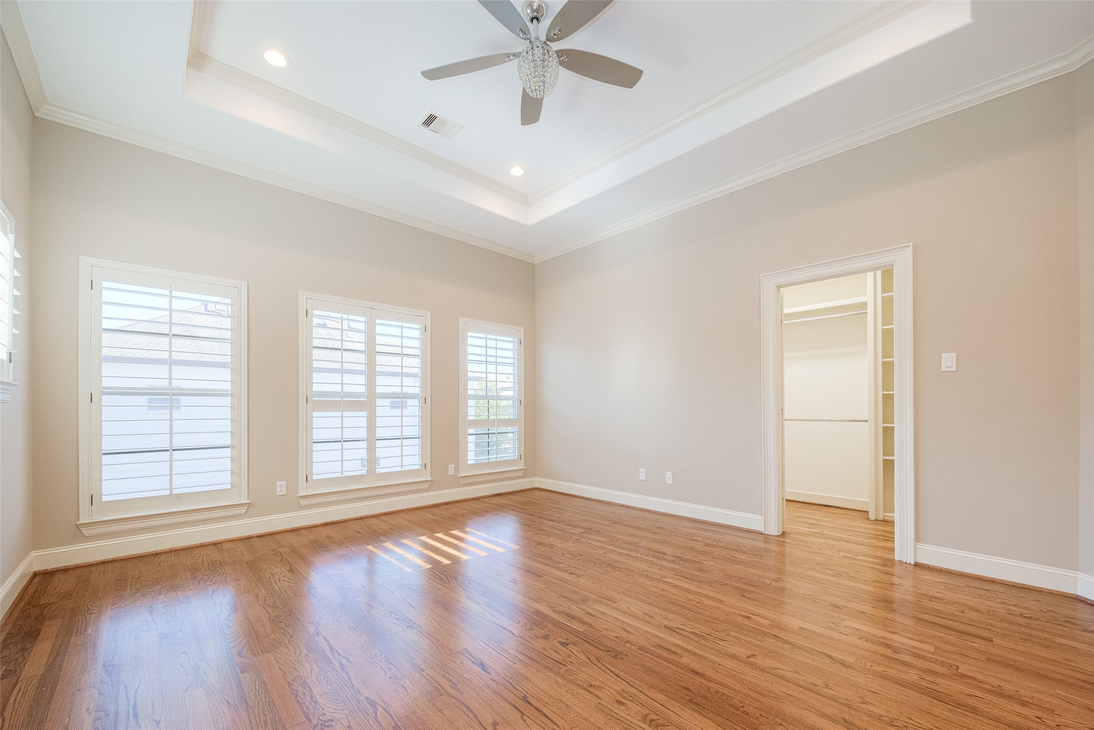 232 Detering Street, Unit A Houston, TX 77007 - Photo 32 of 46 Primary Suite Features Plantation Shutters, Real Wood Floors, Tray Ceiling, Recessed Lighting, Remote Ceiling Fan/Light