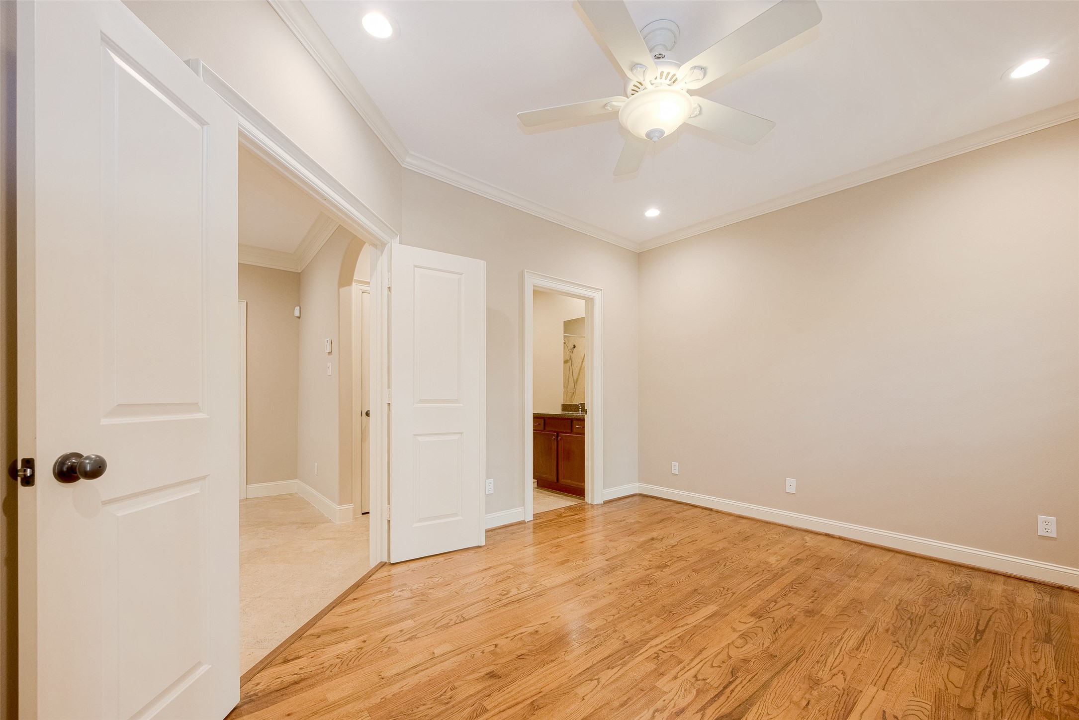 232 Detering Street, Unit A Houston, TX 77007 - Photo 9 of 46 First Floor Bedroom Features Gorgeous Wood Floors, Tall Baseboards, Crown Molding