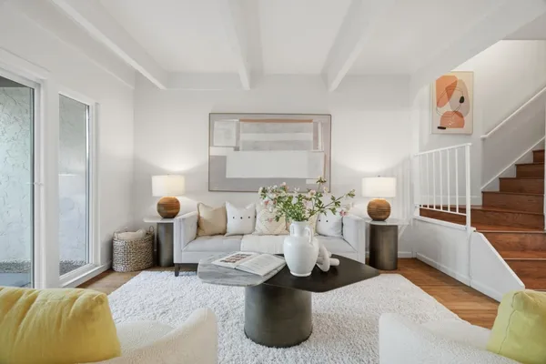 a living room with furniture and stairs