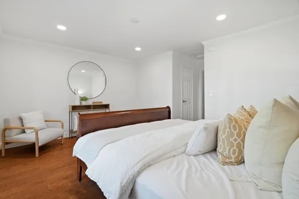 a bedroom with a bed and a chair