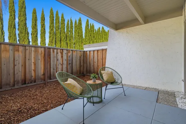 a backyard of a house with table and chairs