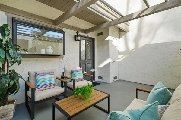 a living room with furniture and a potted plant
