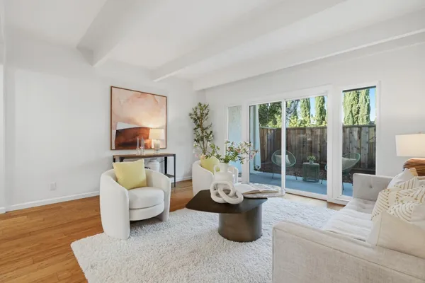a living room with furniture and a potted plant