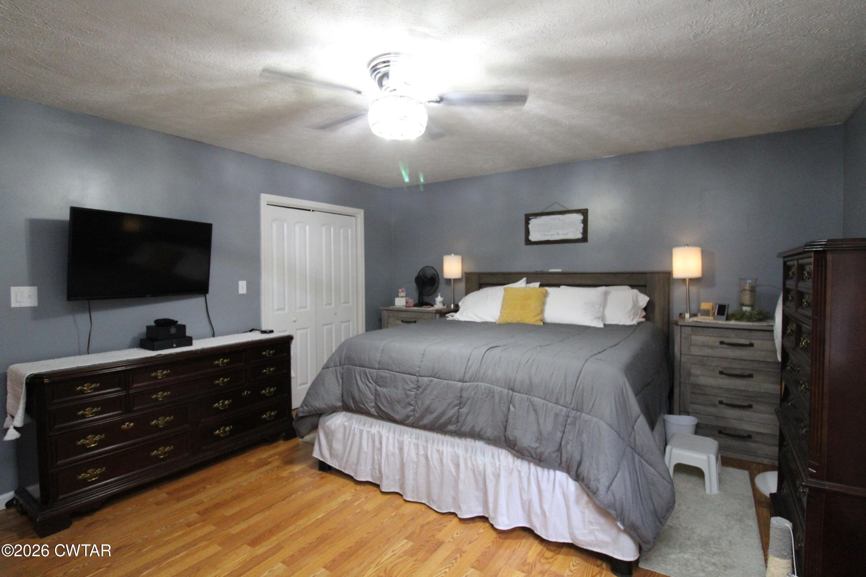 81 Monk Circle Lexington, TN 38351 - Photo 14 of 21 a bedroom with a bed and a flat tv screen on dresser
