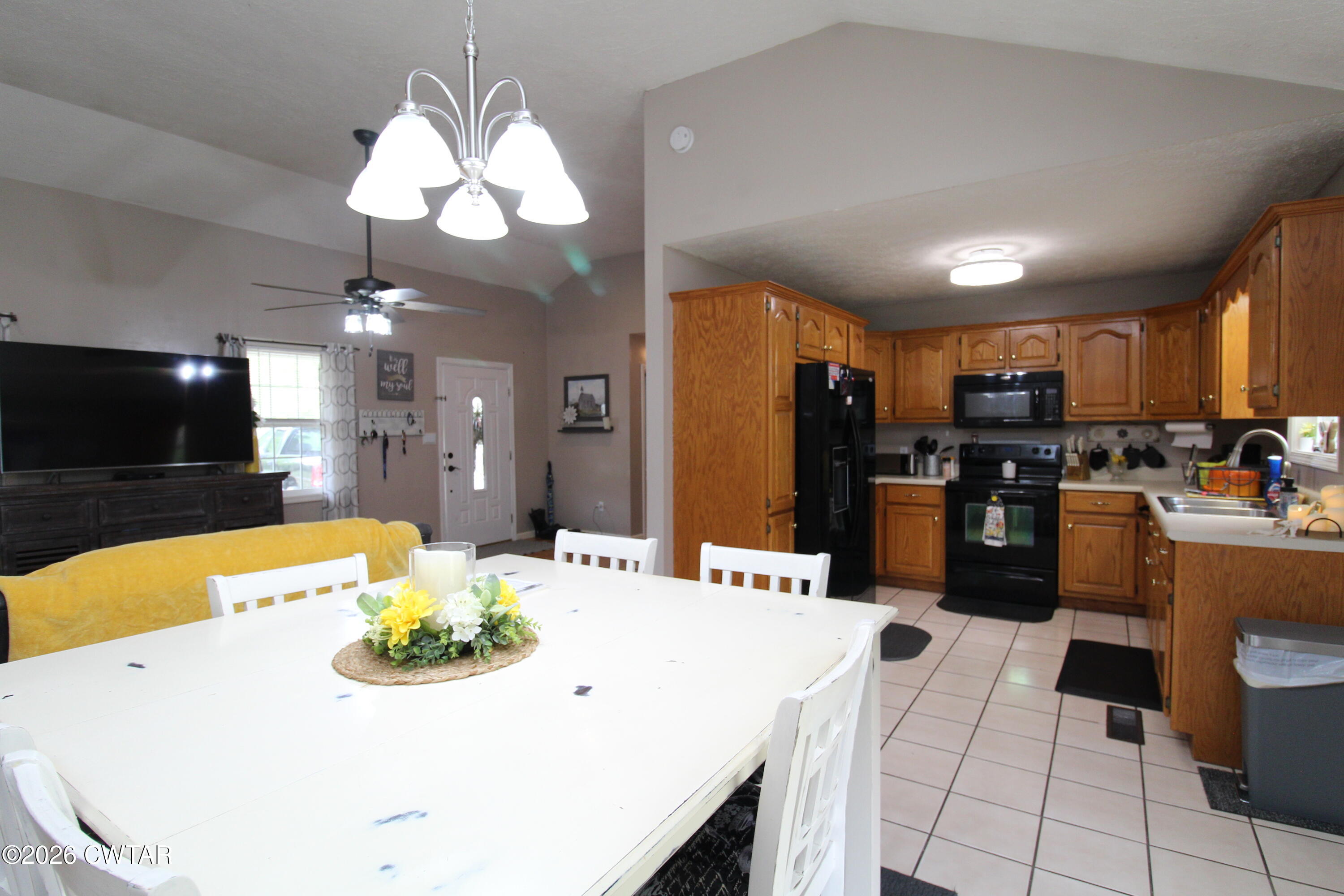 81 Monk Circle Lexington, TN 38351 - Photo 10 of 21 a kitchen with stainless steel appliances kitchen island granite countertop a sink a microwave a refrigerator and chairs