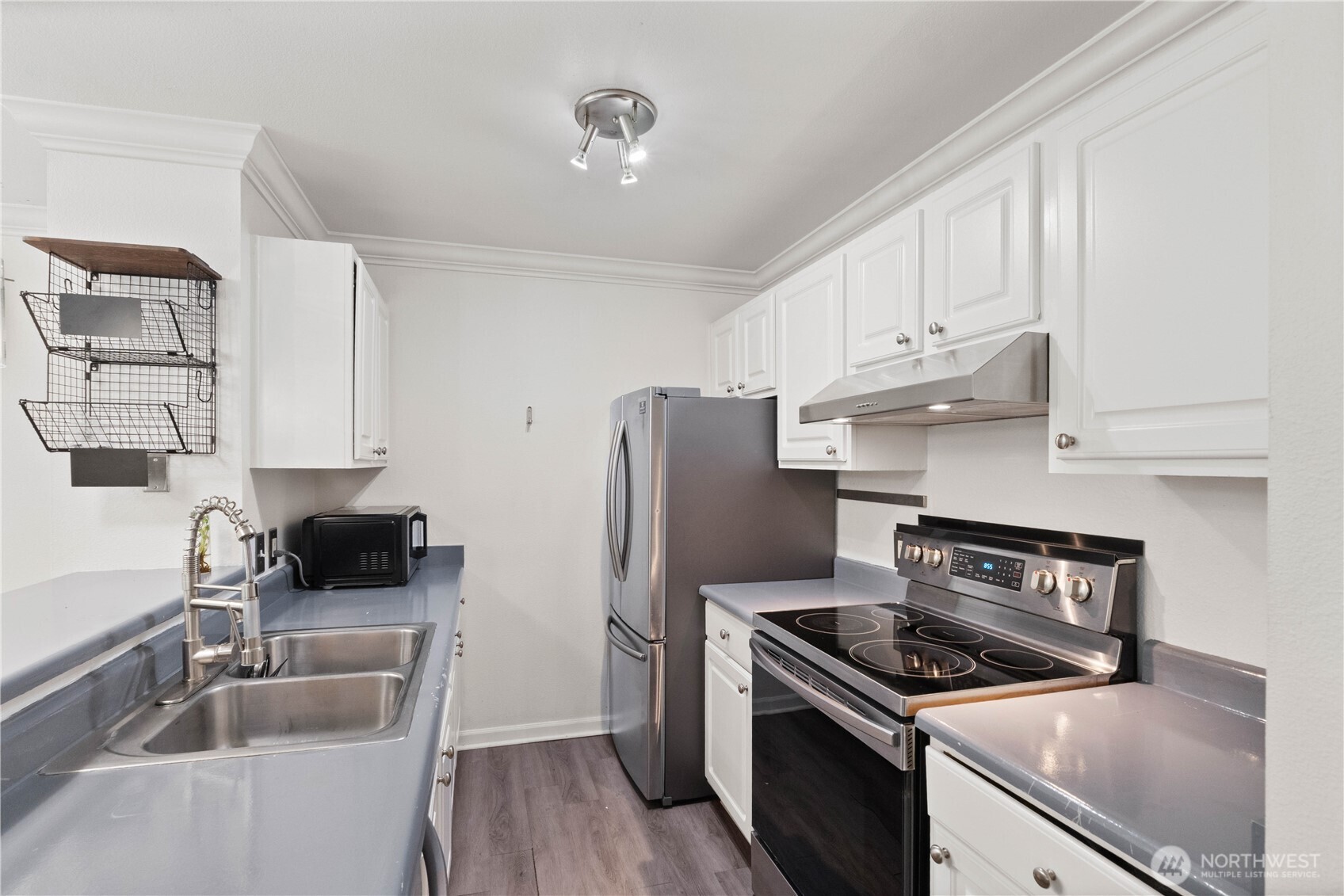 31500 33rd Place Southwest, Unit C203 Federal Way, WA 98023 - Photo 6 of 28 a kitchen with stainless steel appliances granite countertop a sink stove and refrigerator