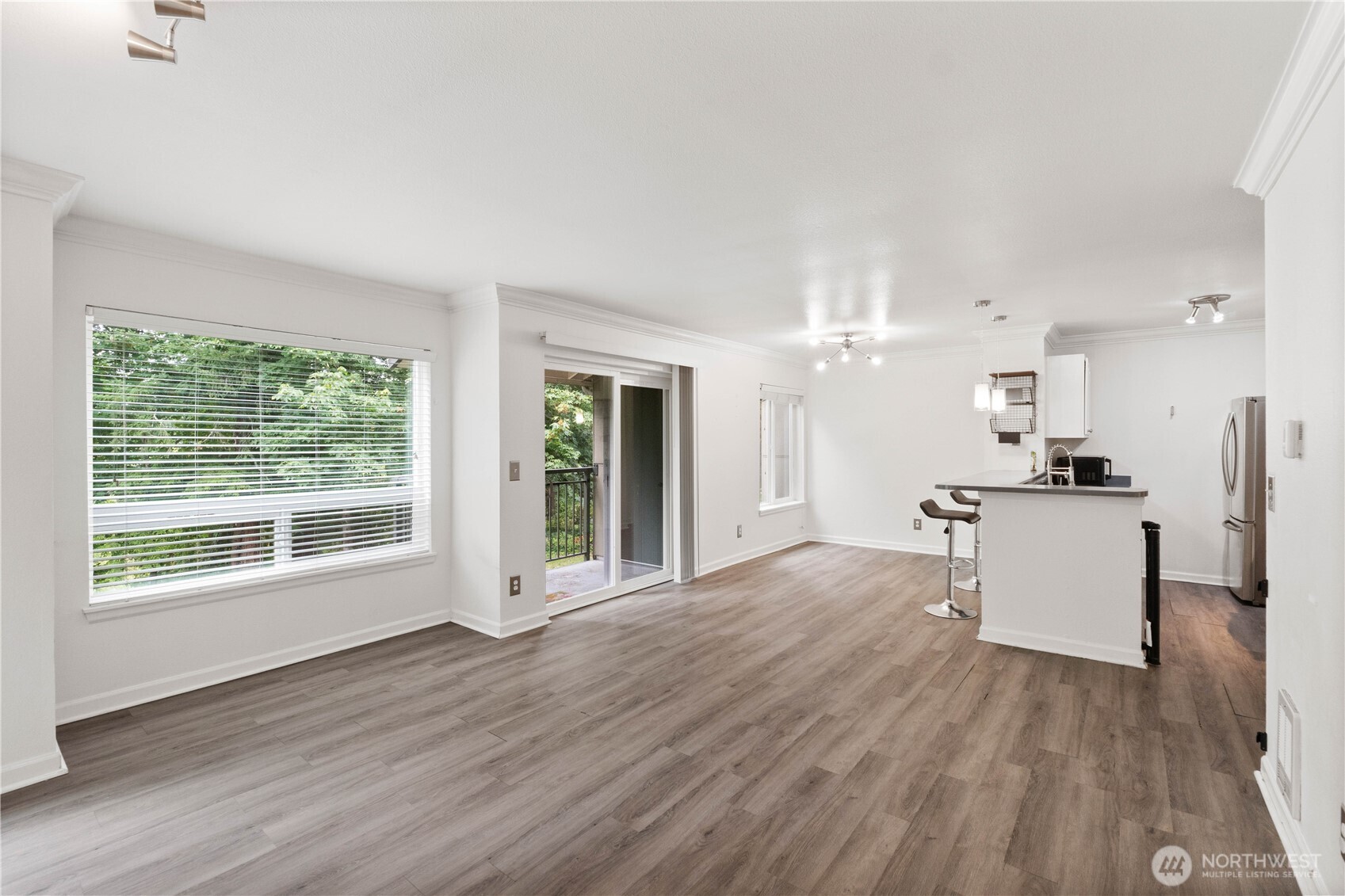 31500 33rd Place Southwest, Unit C203 Federal Way, WA 98023 - Photo 8 of 28 a open kitchen with cabinets stove and a wooden floor