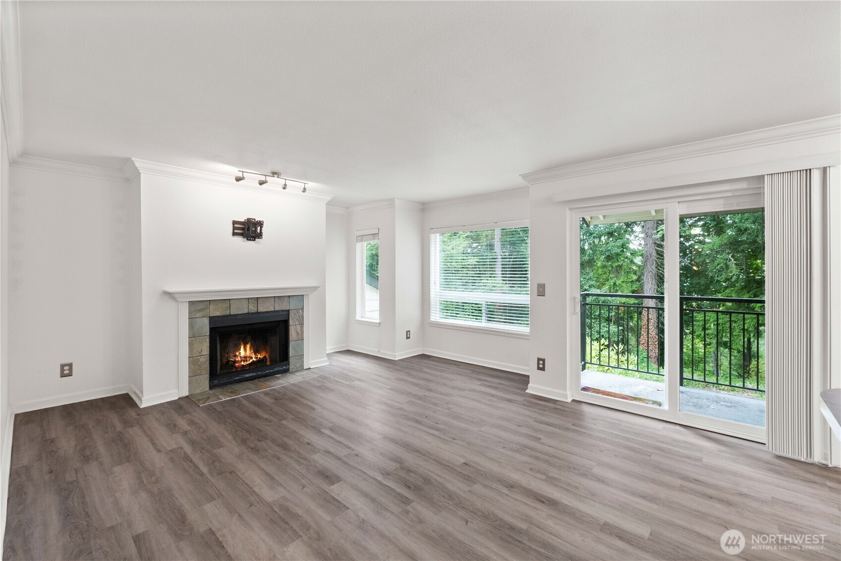 31500 33rd Place Southwest, Unit C203 Federal Way, WA 98023 - Photo 9 of 28 a view of an empty room with wooden floor and a fireplace