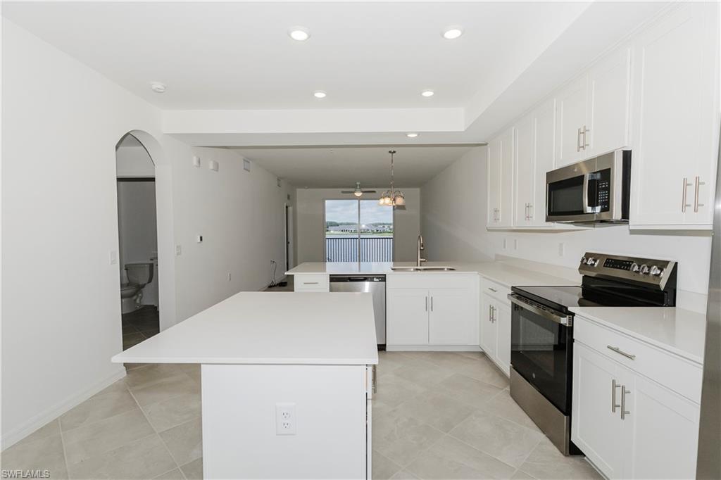 5583 Double Eagle Circle, Unit 4125 Ave Maria, FL 34142 - Photo 1 of 36 a kitchen with a refrigerator stove and microwave