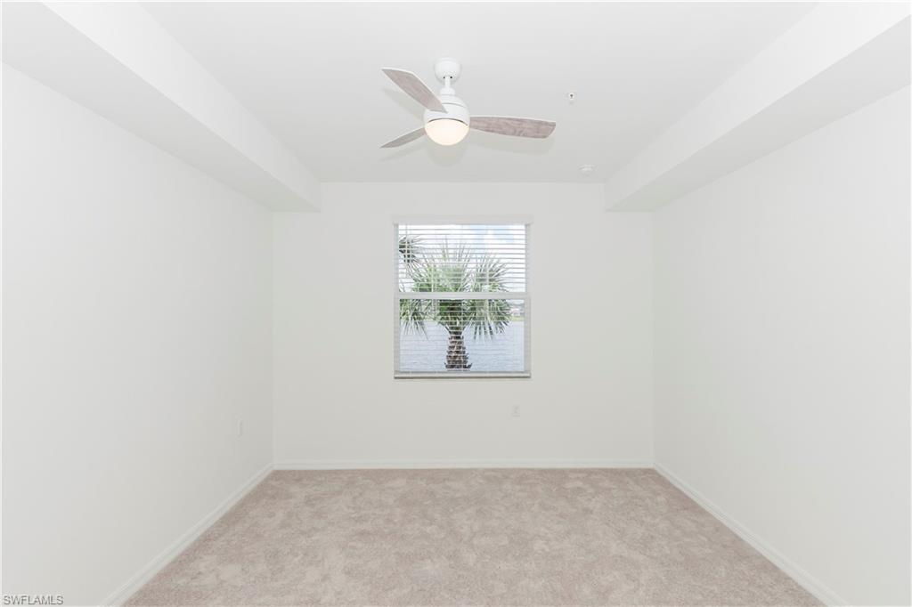 5583 Double Eagle Circle, Unit 4125 Ave Maria, FL 34142 - Photo 4 of 36 an empty room with window and ceiling fan