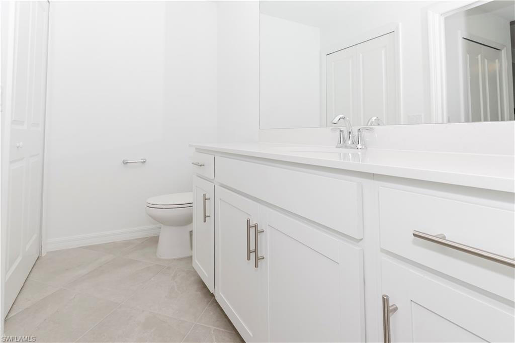 5583 Double Eagle Circle, Unit 4125 Ave Maria, FL 34142 - Photo 5 of 36 a bathroom with a sink and a toilet