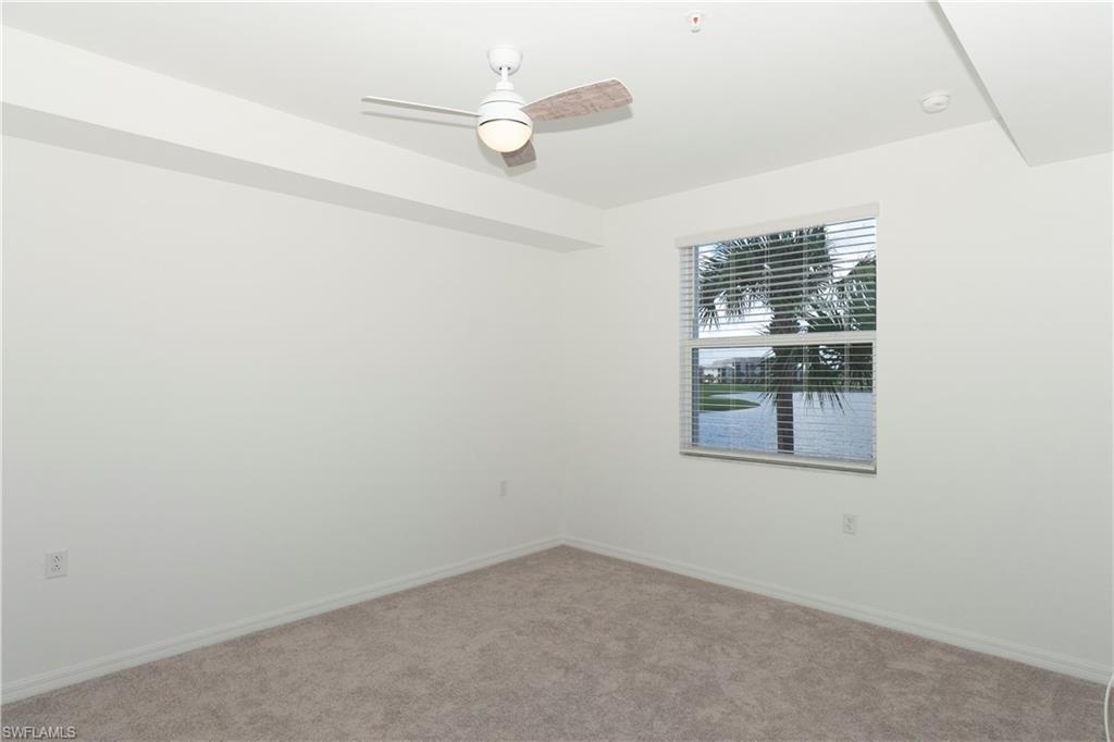 5583 Double Eagle Circle, Unit 4125 Ave Maria, FL 34142 - Photo 6 of 36 an empty room with a window and ceiling fan