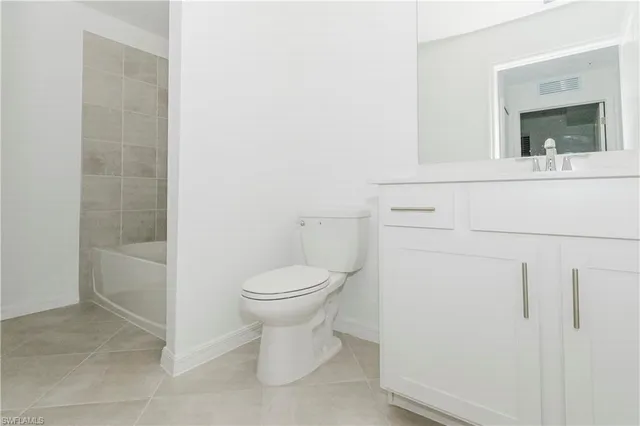 a bathroom with a toilet a sink and shower