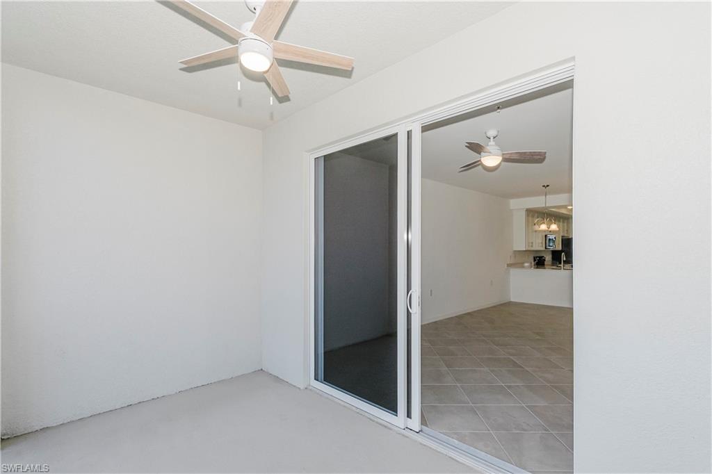 5583 Double Eagle Circle, Unit 4125 Ave Maria, FL 34142 - Photo 9 of 36 an empty room and chandelier fan in hallway