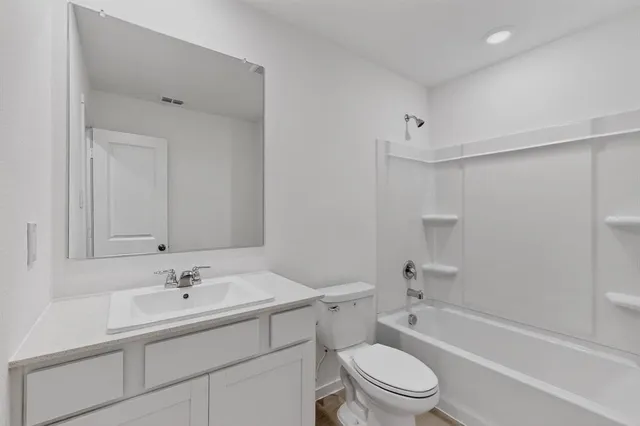 a bathroom with a sink toilet a bathtub and vanity