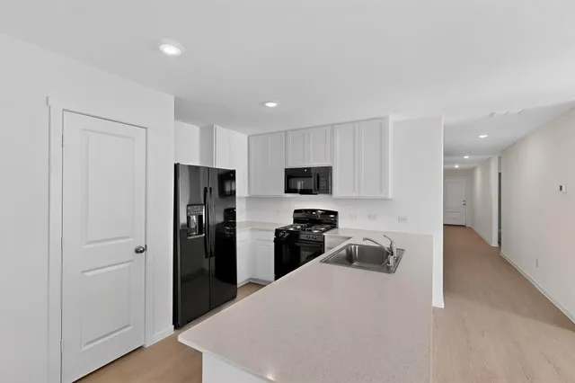 a kitchen with stainless steel appliances a refrigerator and a sink