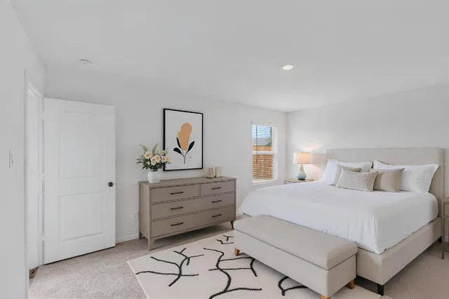 a bedroom with a bed and window