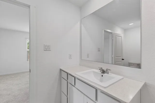 a bathroom with a sink vanity and mirror