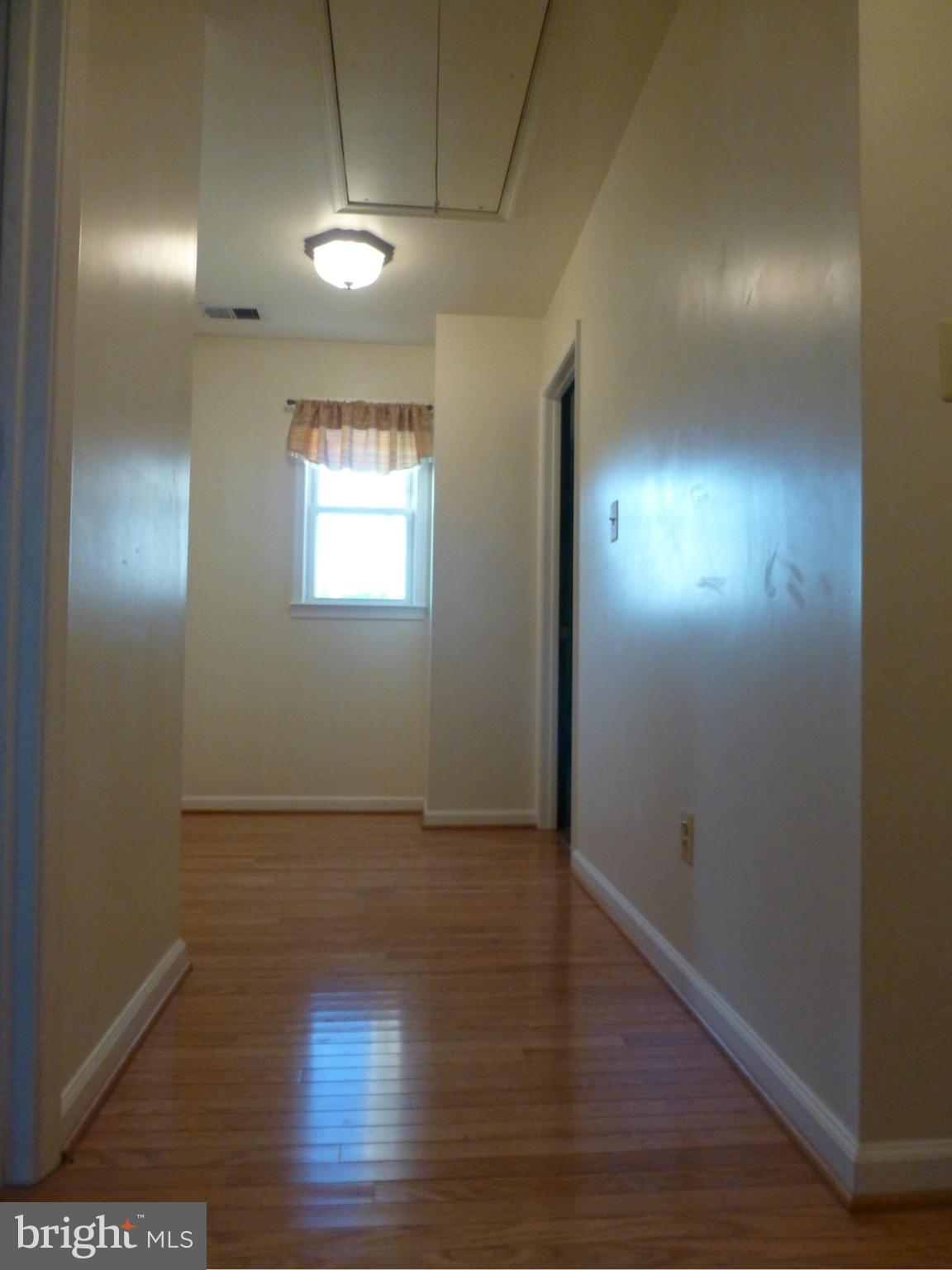 65 Northship Road Baltimore, MD 21222 - Photo 9 of 30 an empty room with wooden floor and windows