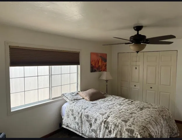 a bedroom with a bed and a window
