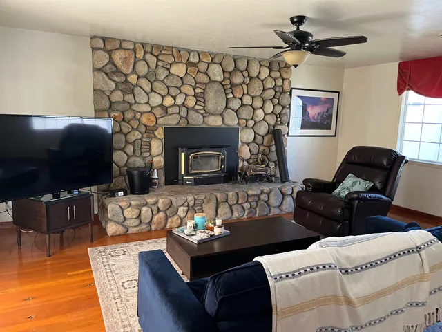 a living room with furniture a flat screen tv and a fireplace
