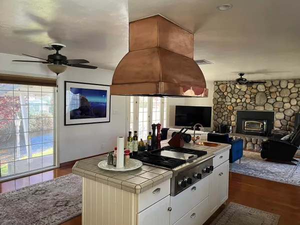 a kitchen with a stove and a fireplace